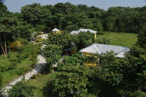 an aerial view of a house in a forest at Jaldapara Inn Resort in Mādāri Hāt