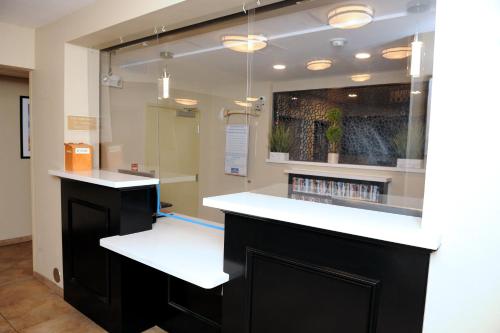 a bar with a white counter in a room at Candlewood Suites Santa Maria, an IHG Hotel in Santa Maria