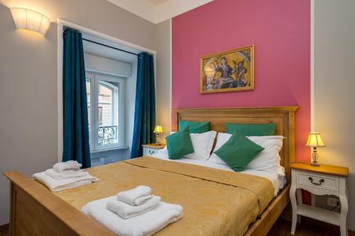 a bedroom with a large bed with towels on it at Raphael Rooms in Rome