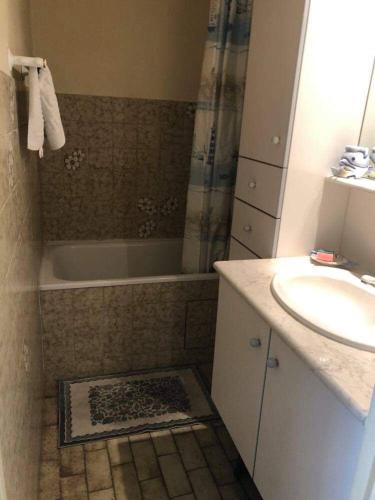 une salle de bain avec un lavabo et une baignoire et un lavabo dans l'établissement Studio 27m2 proche de la plage, au Grau-du-Roi