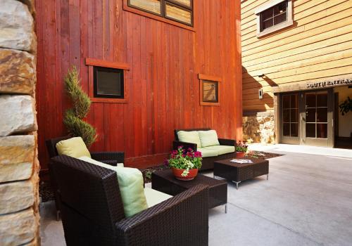 a patio with wicker chairs and tables in front of a building at The White Buffalo Club in Jackson