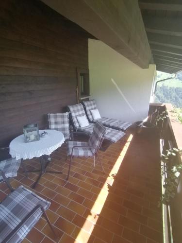 a patio with chairs and a table on a patio at Haus Schwarzmann in Raggal