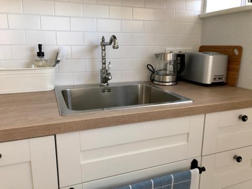 a kitchen counter with a stainless steel sink at Sea View Studio Apartments by the Beach in Ihasalu