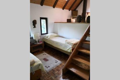 a room with a bunk bed and a ladder at Cherry Tree Villa in Bošnjaci