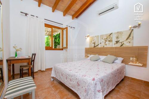 a bedroom in a villa with a bed and a desk at E323 Moli Den Fanals by Mallorca Villa Selection in Alcudia