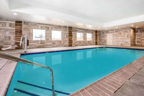 a swimming pool with blue water in a building at La Quinta Inn & Suites Katy-Mills by Wyndham Katy in Katy