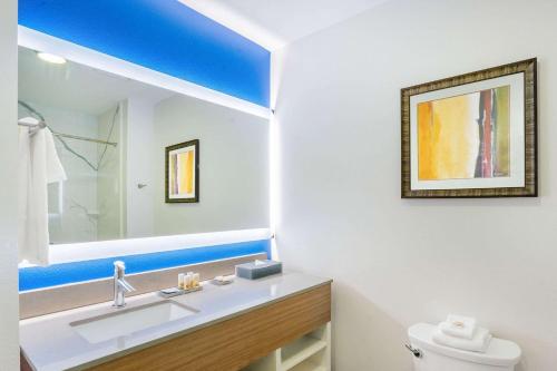 a bathroom with a sink and a mirror at La Quinta Inn & Suites Katy-Mills by Wyndham Katy in Katy