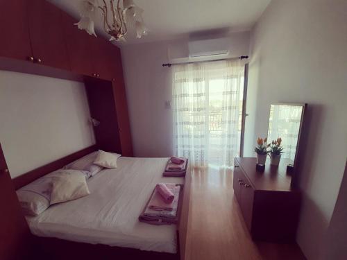 a bedroom with a large bed and a window at Room Luka in Sveti Juraj