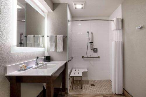 a bathroom with a sink and a shower at La Quinta by Wyndham Anchorage Airport in Anchorage
