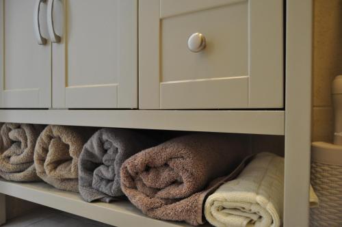 a cabinet filled with towels in a bathroom at Perfect Southern Getaway with Balcony in Eilat