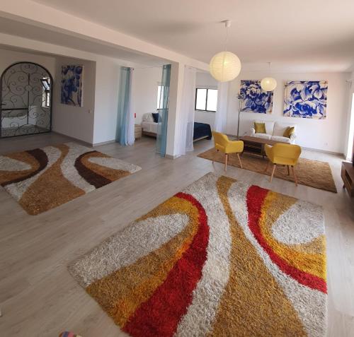 a living room with a large rug on the floor at Casa Concha - Peaceful and Relaxing in Lagos