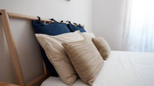 a group of pillows sitting on top of a bed at B&B La Veranda in Licata
