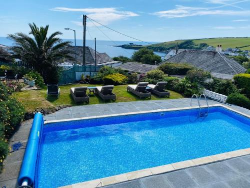 a large swimming pool with a blue roof at Tremarne Hotel in Mevagissey