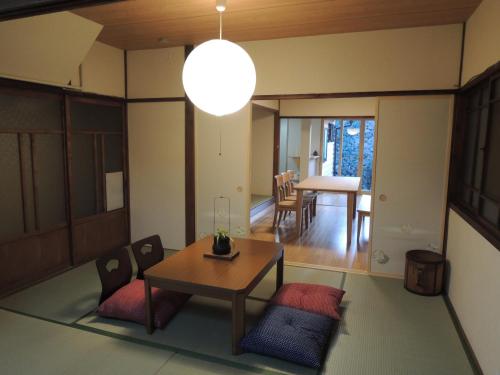 a living room with a table and chairs and a dining room at Kenroku House in Kanazawa