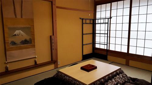 a room with a table in front of a window at Hida House in Takayama