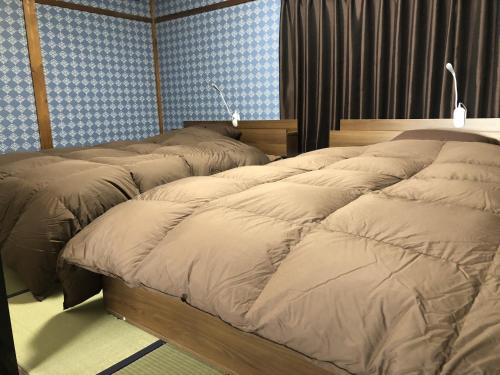 Säng eller sängar i ett rum på Taisho Aburaya