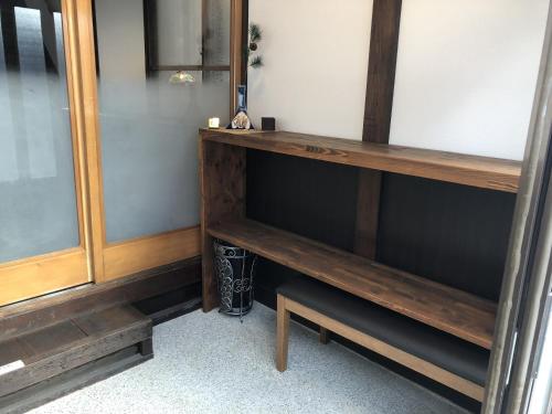 a shelf in a room with wooden furniture at Taisho Aburaya in Takayama