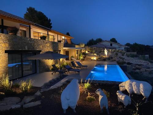 two polar bears standing in front of a house with a swimming pool at VILLA PADI La Cadière d'Azur in La Cadiere d'Azur