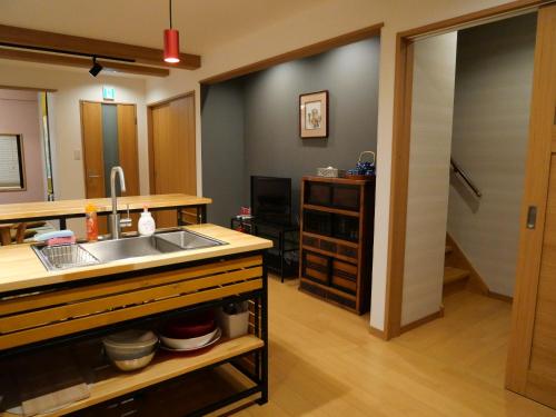 a kitchen with a sink and a counter top at Kanamori House in Takayama