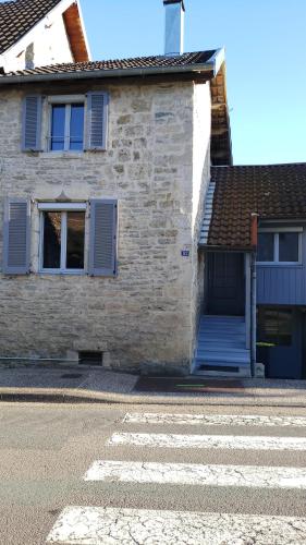 a brick building with a door and a zebra at Gite La Bastide in Ornans