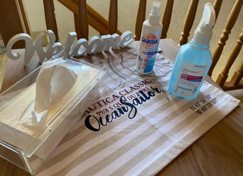 a table with two bottles of cleaning products on a chair at Grosszügig und komfortabel:Ferienwohnung im Bayerischen Wald! in Wiesenfelden