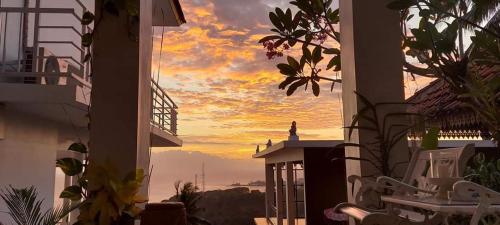 a view of a sunset from the balcony of a house at Villa Aryaguna in Senggigi 