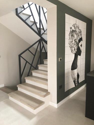 a staircase in a house with a painting on the wall at Superb Design Villa Medulin in Medulin