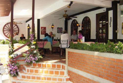 a group of people sitting at a table in a restaurant at Stable Lodge - SHA Certified in Bangkok