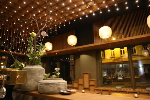 a restaurant with two vases on a table with lights at Hotel de Saxe Leipzig in Leipzig