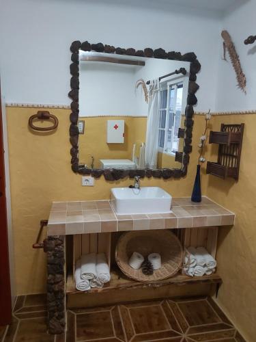 a bathroom with a sink and a mirror at Mirador del Gallego in Santa Maria de Guia de Gran Canaria