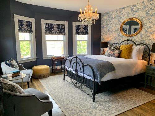 a bedroom with a bed and a chandelier at Slaymaker & Nichols Gastro House & Inn in Charlottetown