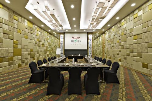 a conference room with a long table and chairs at Meluha - The Fern in Mumbai