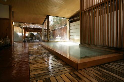 a hallway of a building with a wooden floor at Ryokan Tanigawa in Minakami