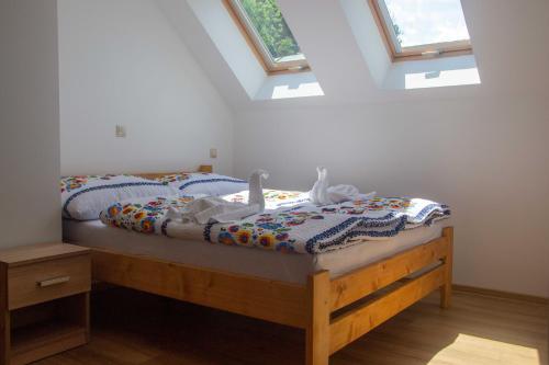 a bed in a bedroom with skylights at Chalupa Anna in Červený Kláštor