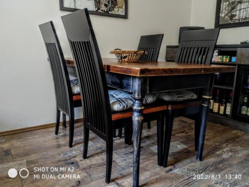 a dining room table with three chairs around it at Holiday home Haustor with Skadar lake view in Podgorica