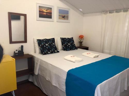 a bedroom with a blue and white bed with a mirror at Mar de Jeri in Jericoacoara