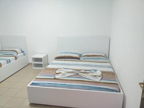 ein Bett mit einem Bogen auf einem Zimmer in der Unterkunft Flat Ergli in Velipojë