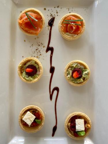 a plate of small appetizers with chocolate sauce on them at Acacia Cliffs Lodge in Taupo