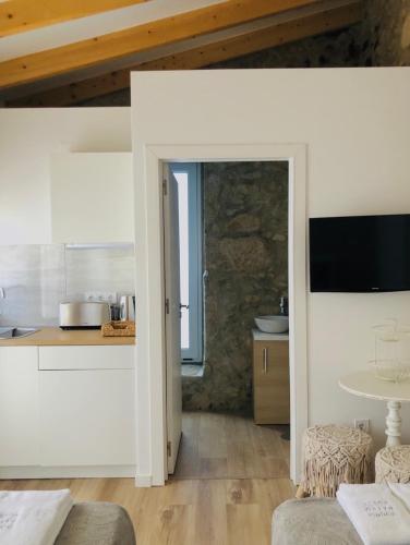 a kitchen with a door leading into a room at Douro Pateo House in Vila Nova de Gaia