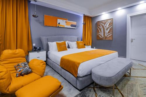 a bedroom with a large bed and a couch at The Alima Suites in Accra