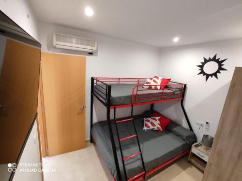 a bedroom with two bunk beds in a room at CHALET ADOSADO DULCINEA Alcossebre in Alcossebre
