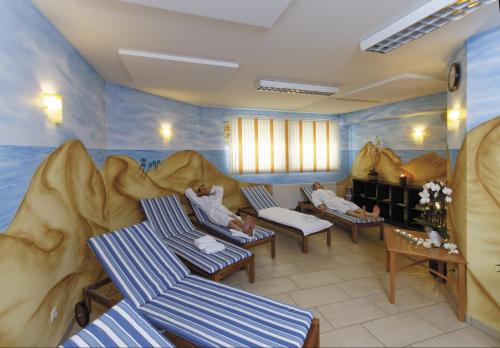 two children laying on chairs in a large room with a play area at Panorama-Hotel am See in Neunburg vorm Wald