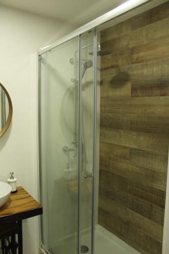 a glass shower in a bathroom with a sink at Casa Pena in Barcelos