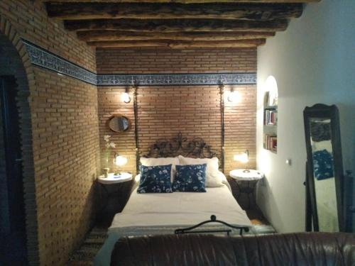 a bedroom with a large bed and two night stands at Casa Maldonado in Yátor