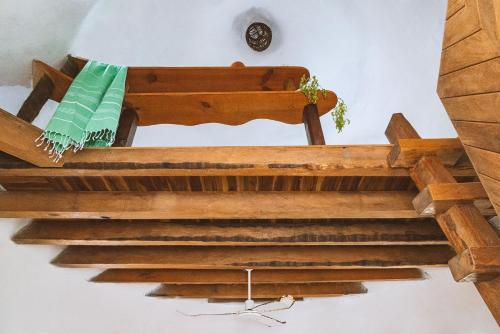 a wooden staircase in a house with a clock on the wall at New Ruins Off-The-Grid SuperAdobe Domes with Pool in San Francisco de Abajo
