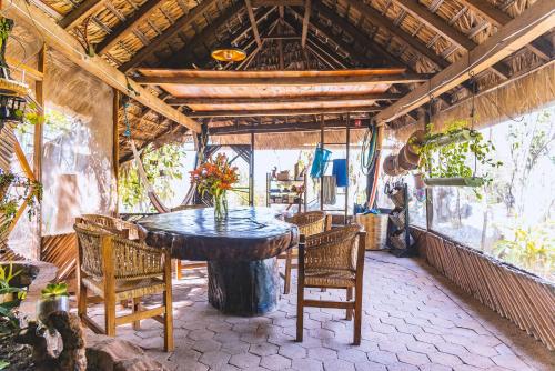 a dining room with a table and chairs at New Ruins Off-The-Grid SuperAdobe Domes with Pool in San Francisco de Abajo