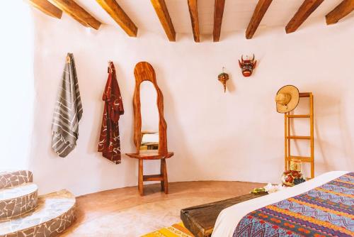a room with a bed and various items on the wall at New Ruins Off-The-Grid SuperAdobe Domes with Pool in San Francisco de Abajo