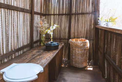 a bathroom with a toilet and a trash can at New Ruins Off-The-Grid SuperAdobe Domes with Pool in San Francisco de Abajo