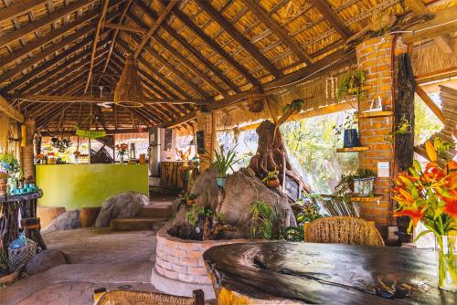 a restaurant with a table and chairs in a room at New Ruins Off-The-Grid SuperAdobe Domes with Pool in San Francisco de Abajo