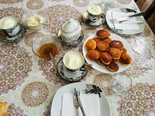 a table topped with plates of pastries and cups of coffee at Salkhino in Salkhino